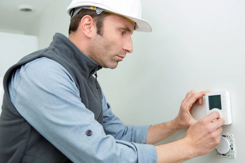 Worker Checking On Thermostat